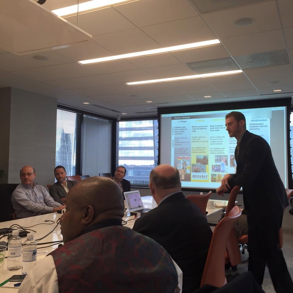 A founder presenting to the room at an early Friday morning gathering.